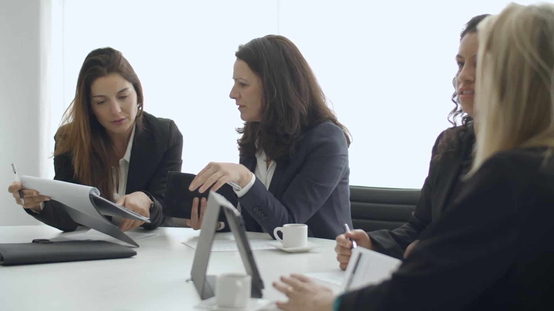 Female leaders discussing work at a meeting